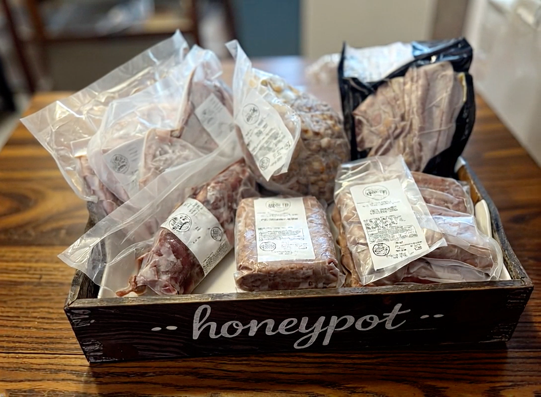 Actual Honey Pot Farmstead pork assortment in wooden farmstead crate; illustrative assortment, not exact Taste of Mangalitsa Box contents